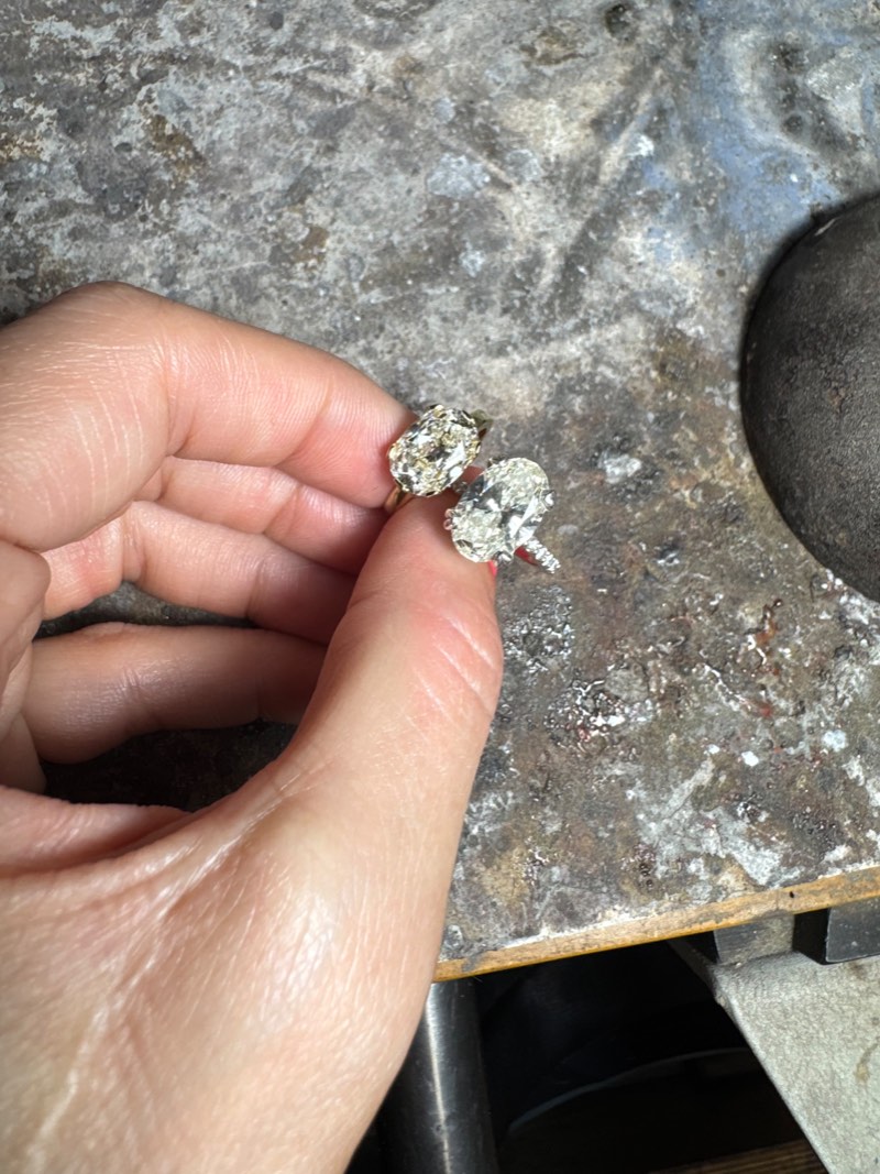 Two rings held side by side at the bench: the smaller-looking stone on the left weighs 2.94ct, while the larger-looking stone on the right weighs 2.84ct.
