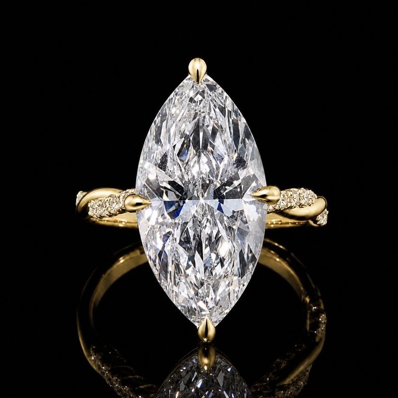 Marquise center in a yellow-metal ring with side stones