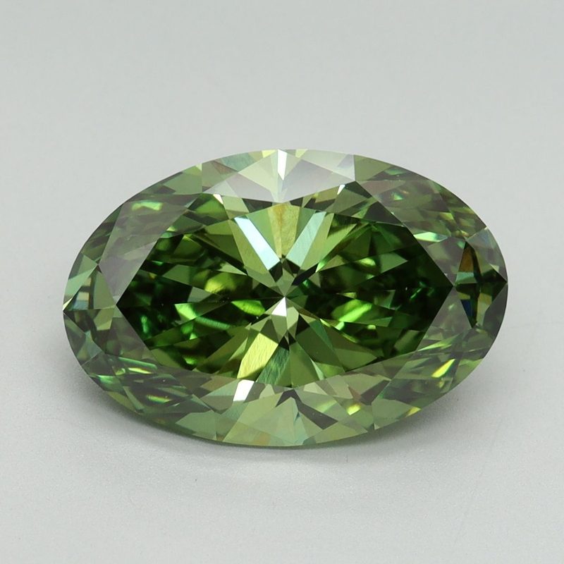 Oval green faceted stone photographed face up