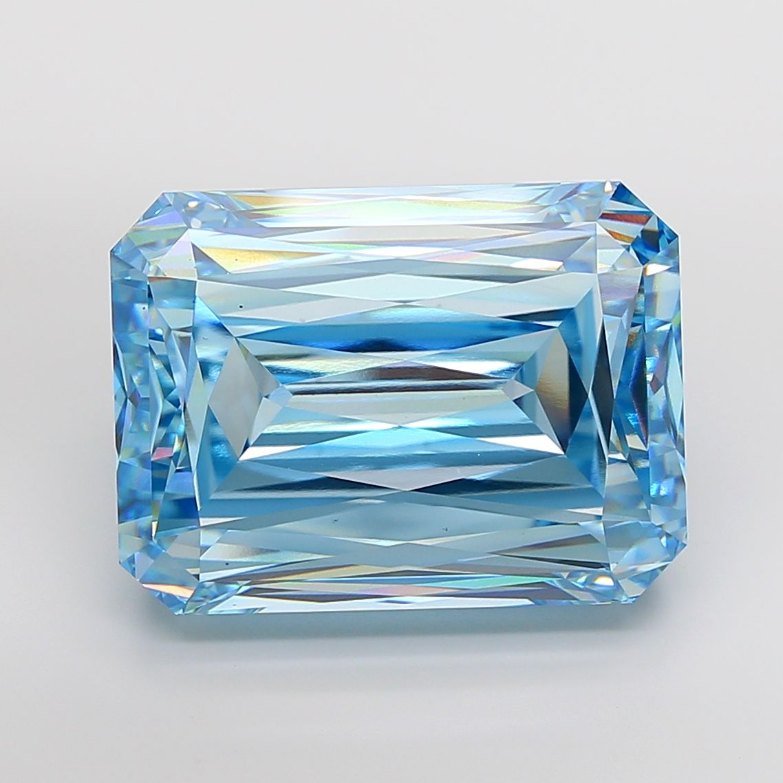 Blue rectangular step-cut diamond photographed face-up