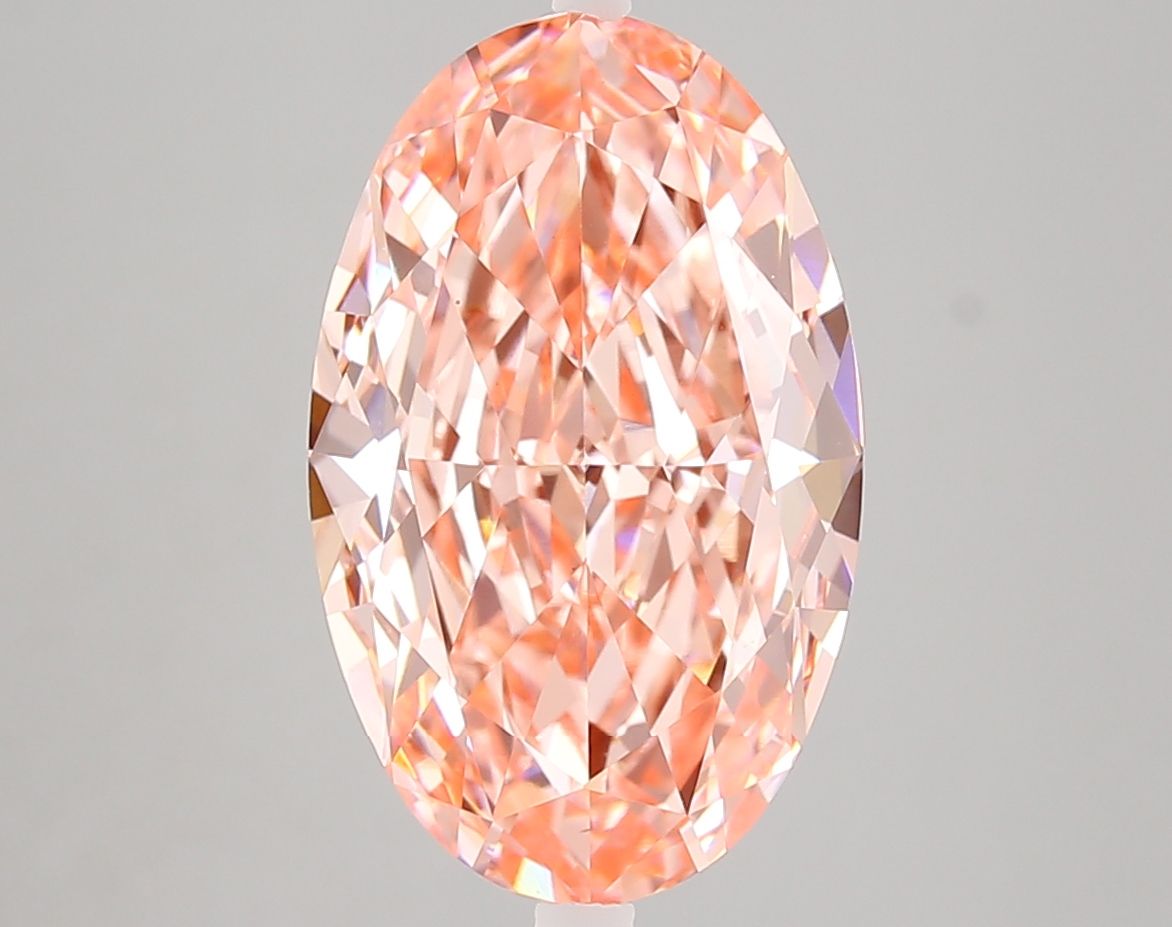 Peach-toned oval diamond photographed face-up