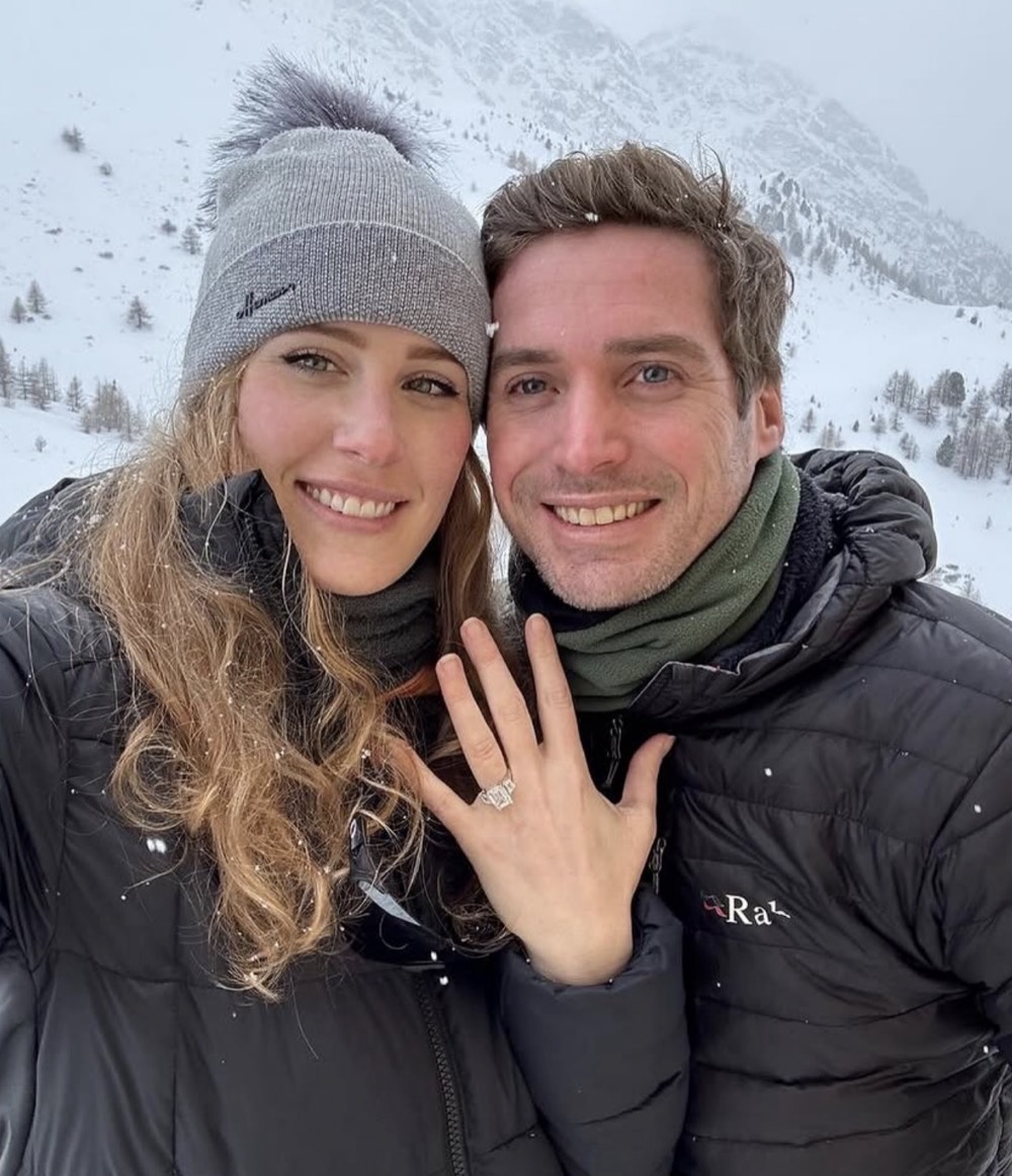 Chloe Alpert, founder of Ring Mint, with her husband JD in the mountains just after their engagement, wearing her own engagement ring